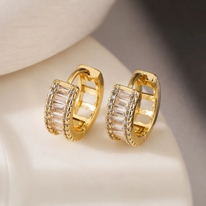 Macro detail of gold plated hoop earrings with rectangular and round cubic zirconia