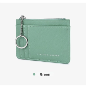 Detail view of mint green cross-grain leather coin purse with key ring and card slots