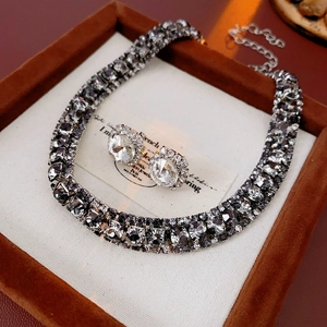 Luxe necklace and round crystal earrings set presented in a brown velvet jewelry box
