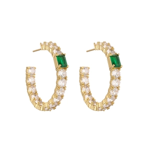 Detail of gold-plated earrings with rectangular green stones and white zircons