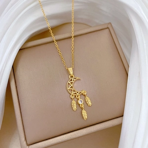 Elegant gold titanium dreamcatcher necklace with moon pendant and feather tassel details