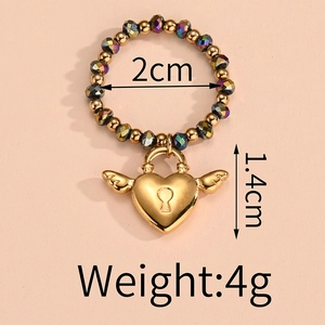 Detail of beaded elastic ring featuring gold heart lock charm and dimension markings