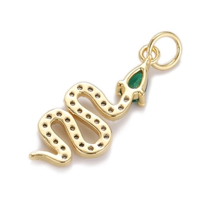 Macro shot of gold snake pendant featuring a teardrop green gemstone and textured scales