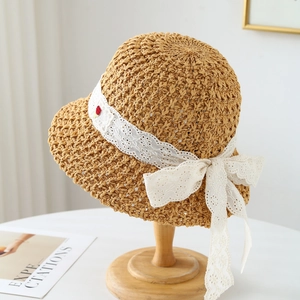 Handwoven straw sun hat with white lace ribbon bow and floral embroidery for summer beach trips
