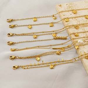 Set of seven minimalist gold plated stainless steel layered bracelets with heart and pearls