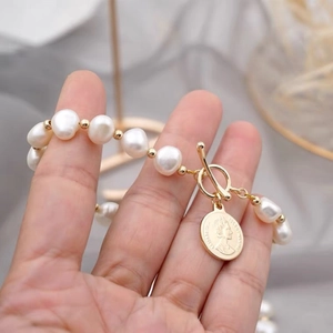 Elegant freshwater pearl bracelet with gold coin pendant and T-bar clasp for women