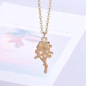 Macro shot of 18k gold plated stainless steel 3D rose pendant and delicate link chain
