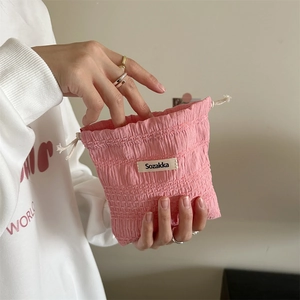 Detail view of pink waffle textured drawstring pouch for small items and makeup