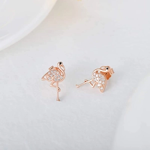 Detailed macro view of rose gold flamingo earrings with brilliant white cubic zirconia