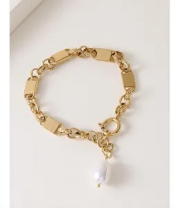 Detail of 18k gold-plated chain bracelet with metal plates and freshwater pearl drop
