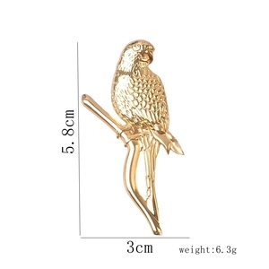 Detail showing dimensions of golden parrot brooch with 5.8cm height and 3cm width