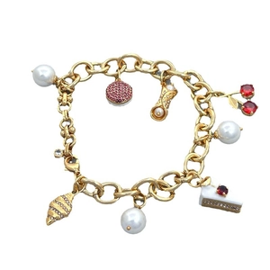 Golden charm bracelet with cherry and croissant pendants featuring pearls and zircon