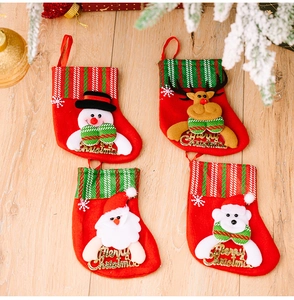 Close-up of four Christmas stockings with Santa, reindeer, snowman, and bear characters