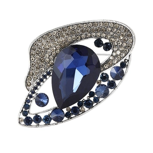 European vintage silver brooch featuring a large pear-cut deep blue crystal centerpiece