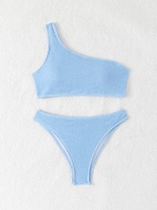 Detailed view of light blue seersucker bikini with textured one-shoulder top and high-cut bottom