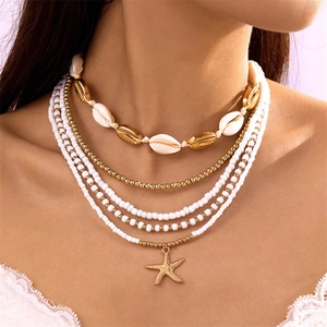 Bohemian multilayer necklace set with gold starfish charms and white seed beads