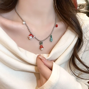 Detailed view of Christmas necklace with colorful enamel charms on a silver beaded chain