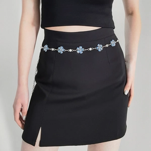 Close-up of elegant silver chain belt featuring blue flowers and sparkling rhinestones