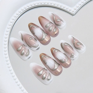 3D metallic pink ombre press on nails set displayed on a heart-shaped mirror