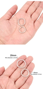 Detail of silver DIY jump rings in 18mm and 20mm sizes on hand for scale reference