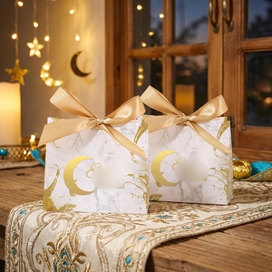 Close-up of Eid Mubarak candy box with gold foil moon, marble pattern, and silk ribbon