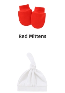 Detail of red knit newborn gloves and white knotted baby hat in soft cotton fabric