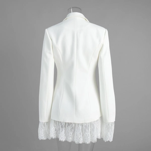 Detail view of white slim blazer featuring exquisite lace patchwork on the back hem