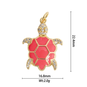 Macro shot of gold turtle pendant with red enamel shell and crystal rhinestones