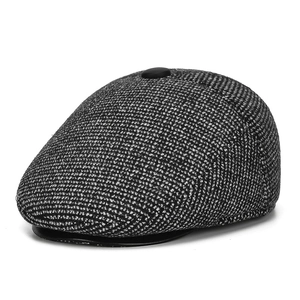 Close-up of grey plaid texture on winter flat cap with detailed wool blend fabric weave