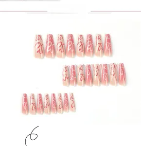 Close-up of pink gradient long ballet press-on nails with heart line art design