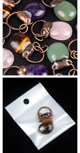 Macro shot of assorted natural stone pendants with vintage bronze metal in packaging