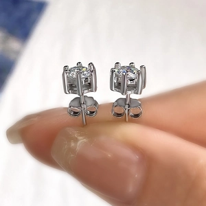 Detailed view of classic six-prong moissanite stud earrings in polished S925 sterling silver
