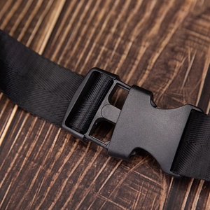 Detail of durable black plastic buckle and premium nylon webbing on the crossbody bag