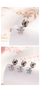 Macro detail of mini floral cartilage stud earrings with pink and blue zircon stones