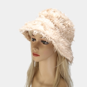 Detailed plush texture of a beige faux fur bucket hat for winter warmth