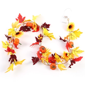 Autumn garland with maple leaves, pumpkins and warm LED lights for home wall decoration