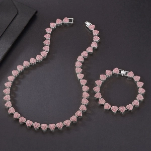 Silver Cuban link necklace and bracelet set with pink crystals in heart-shaped links