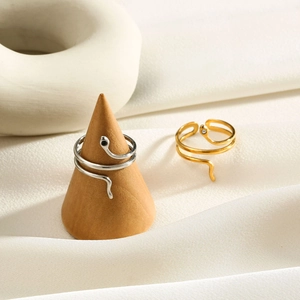 Detail of adjustable snake wrap rings in gold and silver with zircon stone settings