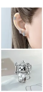 Detailed view of cat chef stud earring with heart zircon and crown on model ear