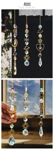 Detail of galaxy suncatchers with gold metal celestial charms and crystal prisms