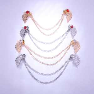 Detail view of angel wing collar pins with tassels and colorful zircon stones