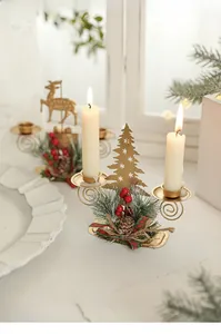 Golden double candle holder with hollow Christmas tree, pine cones and red berries detail