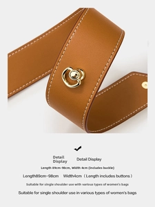 Adjustable brown pebbled leather shoulder strap with white stitching and gold buckles