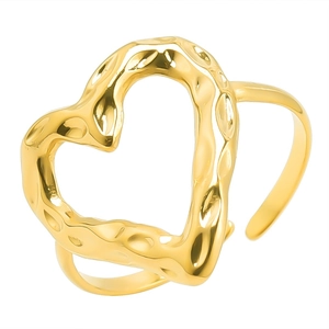 Detailed macro view of gold heart ring featuring a unique hammered metal texture and open band