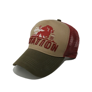 Detail of vintage trucker hat with bull embroidery, red mesh back, and contrast stitching