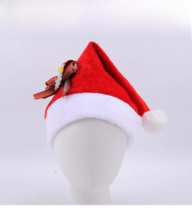 Close-up of red plush Christmas hat with brown Merry Christmas ribbon and snowflake charm