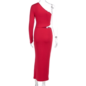 Macro detail of red long sleeve dress showing high slit cut and textured knit fabric