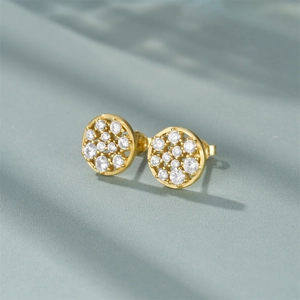 Close-up of gold-plated 925 sterling silver round stud earrings with white zircon paving