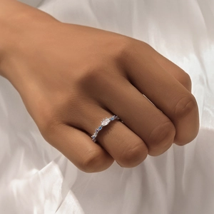 Detailed view of silver star ring with blue micro-pave crystals on white silk