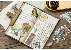 Flat lay of vintage washi stickers with butterfly and floral motifs on dark wood